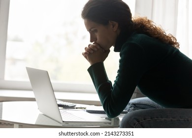 Financial Problem. Thoughtful Hispanic Woman Sit By Home Laptop Lean On Clasped Hands Consider On Tax Loan Credit Debt. Upset Young Lady Freelancer Understand Her Small Business Is Close To Bankruptcy