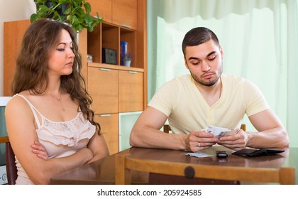 Financial Problems In Family. Sad Couple With Money 