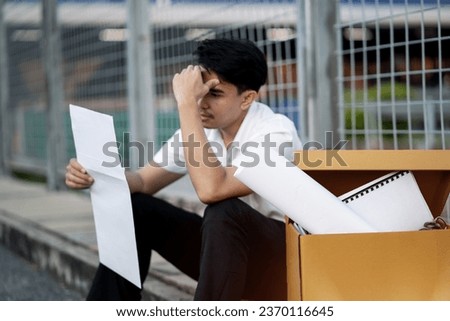 Financial problems. Young man stressed reading invoice letter. receiving bad news Bad financial report. Failed exam. Sad and stressed businessman.