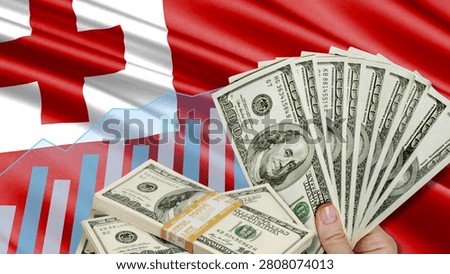 The financial relationship between the US dollar, the role of foreign currency, and Tonga's development. The image includes a hand holding a dollar bill, the Tongan flag, and a growth chart.