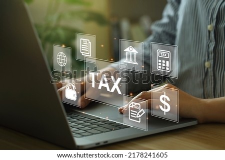 Financial research, government taxes, and calculation tax return concept. Business Woman using the laptop to fill in the income tax online return form for payment.Calculation tax return. tax and vat