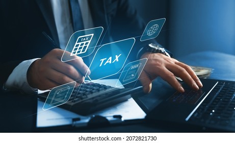 Financial research,government taxes and calculation tax return concept. Businessman using the laptop to fill in the income  tax online return form for payment.  - Shutterstock ID 2072821730