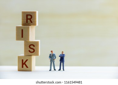 Financial risk assessment / portfolio risk management concept : Miniature figurine two top management businessmen have dialog, discuss on topics about company risk or fraud and method to avoid crisis - Shutterstock ID 1161549481