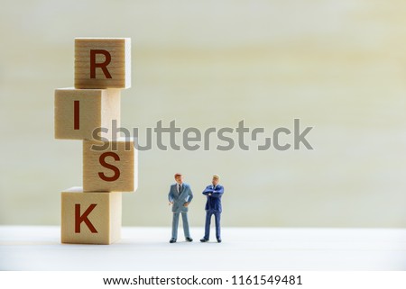 Financial risk assessment / portfolio risk management concept : Miniature figurine two top management businessmen have dialog, discuss on topics about company risk or fraud and method to avoid crisis