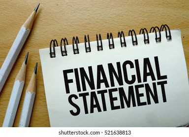 Financial Statement text written on a notebook with pencils