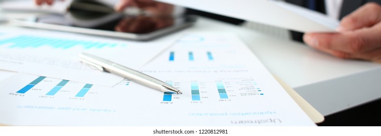 Financial Statistics Documents Ball Pen Infographics At Office Table Closeup. Internal Revenue Service Inspector Sum Check Investigation Exchange Market Earnings Savings Loan And Credit Concept