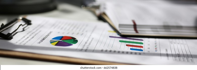 Financial Statistics Documents On Clipboard Pad At Office Table Closeup. Internal Revenue Service Inspector Sum Check, Irs Investigation, Exchange Market, Earnings, Savings, Loan And Credit Concept