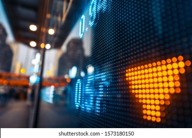 Financial stock exchange market display screen board on the street  with city scene reflect on glass