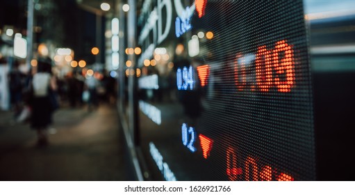 Financial Stock Exchange Market Display Screen Board On The Street With And City Light Reflections, Selective Focus