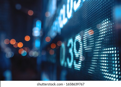 Financial Stock Exchange Market Display Screen Board On The Street With And City Light Reflections, Selective Focus