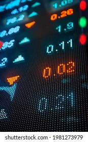 Financial Stock Exchange Market Display Screen Board On The Street With And City Light Reflections, Selective Focus