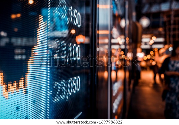 Financial stock exchange market display screen\
board on the street, selective\
focus