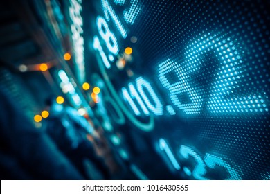 Financial stock market numbers and city light reflection