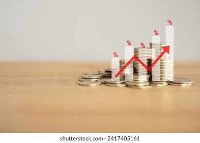 Financial Success Graph with pile of golden Coins on wooden desk with copy space , Chart, Percent symbol and red upward arrow.  Financial concept background.  