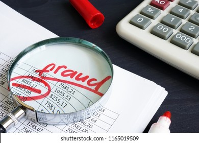 Financial or taxes fraud. Business report and magnifying glass.
