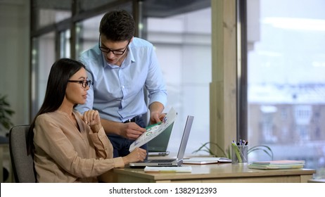 Financiers of large company comparing supply and demand graphs before reporting - Shutterstock ID 1382912393