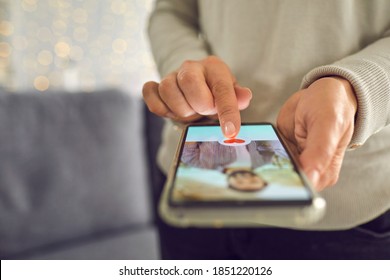 Find love online concept. Adult woman pressing red heart like button below handsome man's profile photo on dating app. Close-up of female hands holding mobile phone. Soft focus, selective focus, blur - Shutterstock ID 1851220126