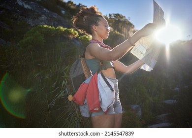 I Find This Map Super Helpful. Shot Of A Young Woman Holding Up A Map While Out In The Mountains.