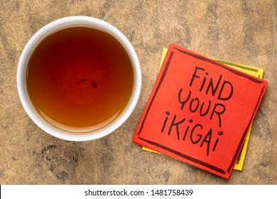 find your ikigai handwriting, reminder note with a cup of tea - Japanese concept  of a reason for being of life purpose