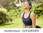 Find your sweet spot. a young woman doing a cobra stretch while exercising outdoors.