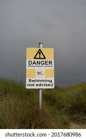 Findhorn, Scotland, UK - August 1 2021: Danger Strong Inshore Currents Swimming Not Advised Sign With Icons. Authentic, On Beach Path. No People.