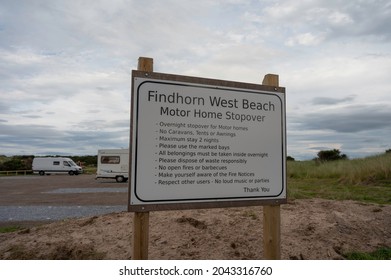 Findhorn, Scotland, UK, September 17 2021: Sign For Findhorn West Beach Motor Home Stopover. Blurred Background Of Site With Two Motorhomes. Overcast Day, No People.