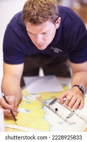 Finding the co-ordinates of a lost person. Cropped shot of a handsome young male lifeguard finding co-ordinates on a map in their office. - Shutterstock ID 2228925833