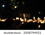 finding the light in dark. a haza candlelight vigil find each other in darkness, blur background in hong kong victoria park in 64 anniversary