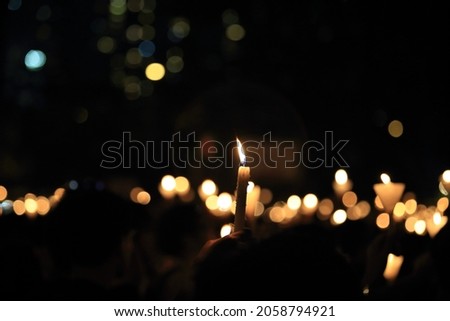 finding the light in dark. a haza candlelight vigil find each other in darkness, blur background in hong kong victoria park in 64 anniversary