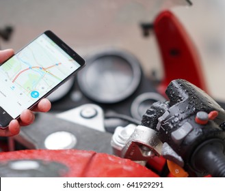 Finding a location on google maps using the mobile gps navigation on a smartphone. Selective focus
