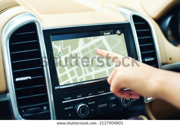 Finding locations the
efficient and easy way. Shot of an unrecognizable woman using a gps
in a car.