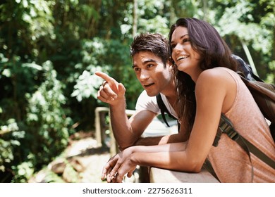 Finding so many beautiful things along the trail. a young couple enjoying the scenery while out hiking through the forest. - Powered by Shutterstock