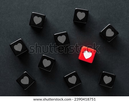 Finding a match in social media. To find love. Online love or matching in dating apps. Heart symbols on black cubes