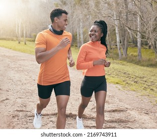 Finding Our Pace Together. Shot Of Two Young Friends Running Outside Together During The Day.