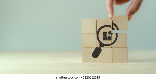 Finding solutions concept. Business problem solving, make decision. New ideas and innovation. Team brainstorming to set strategies. Hand holds wooden cubes with magnifying glass and puzzle jigsaw icon - Shutterstock ID 2120612315
