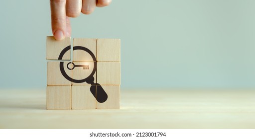 Finding solutions concept. Business problem solving and make decision. New ideas and innovation. Team brainstorming to set strategies. Hand holds wooden cubes with magnifying glass and key icon. - Shutterstock ID 2123001794