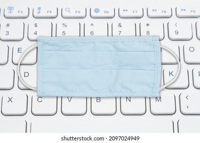 Finding Your Covid Information Online With A Keyboard And Blue Cloth Face Mask