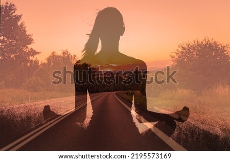 Finding your inner peace, getting away form it all, and free your mind concept. Woman meditating facing a empty country road. 