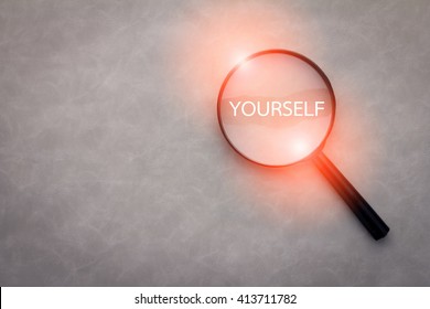 Finding Yourself Concept With Word And Magnify On Grey Leather Background.jpg