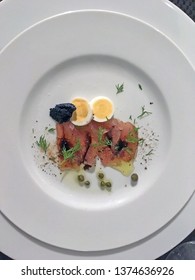 A Fine Appetizer Plate With Ahi Tuna Carpaccio In Olive Oil, Quail Eggs, Caviar And Capers