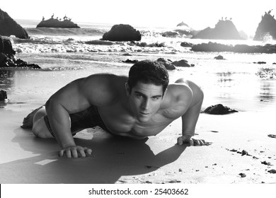 Fine Art Black And White Photo Of A Young Muscular Man Crawling On Beach