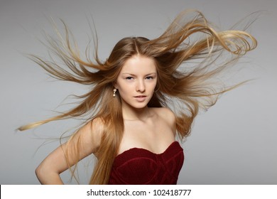 Fine Art Fashion Portrait Of Blond Fashion Model Posing With Hair Fluttering In The Wind
