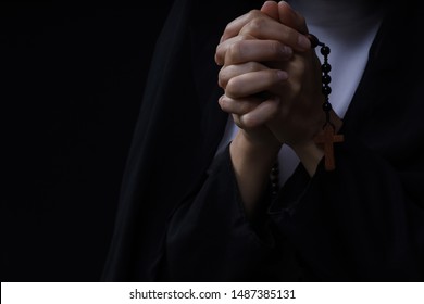 fine art portrait of a novice nun in deep prayer with rosary - Shutterstock ID 1487385131