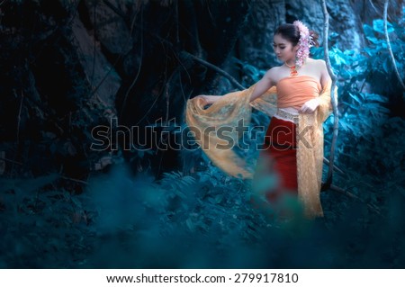fine art portrait of thai woman wearing Thai dress in wild