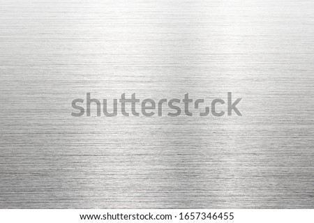 Fine brushed metal with reflection. Photograph of brushed metal, or hair line pattern metal. High resolution Sharp to the corners.