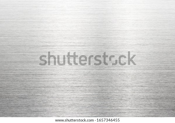 Fine brushed metal with reflection. Photograph\
of brushed metal, or hair line pattern metal. High resolution Sharp\
to the corners.