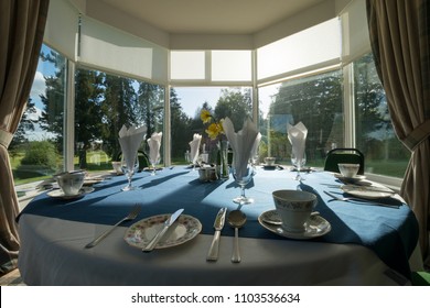 Fine China Set On A Table In A Bay Window Bathed In The Afternoon Sunlight 