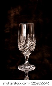 Fine Cut Crystal Glass Isolated Over Brown