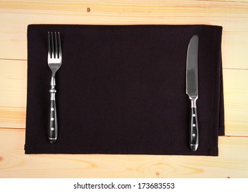 Fine Cutlery On Black Placemat As Menu Board, Top View