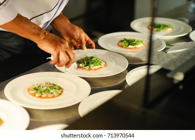 Fine dining chef decorating a white plate with seafood dish.Food decoration.Food concept. - Powered by Shutterstock